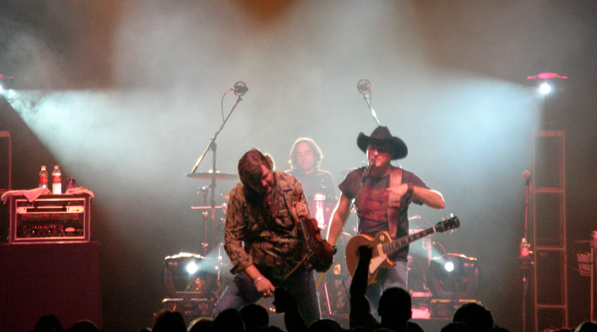 Country act performing under stage lighting